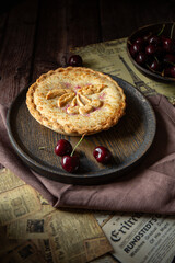 Cherry pie on dark brown background 