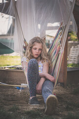 bored teenage girl in hammock swing - 721586243