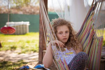 bored teenage girl in hammock swing - 721586270