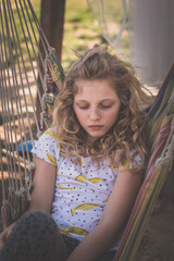bored teenage girl in hammock swing - 721586273