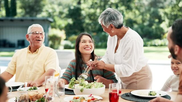 Food, thanksgiving and grandparents with family or child at table outdoor for celebration or tradition. Salad, sharing or lunch with people, grandma and kid eating meal together in a social gathering