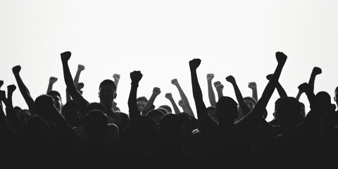 A crowd of people raising their hands in the air. Suitable for various events and celebrations