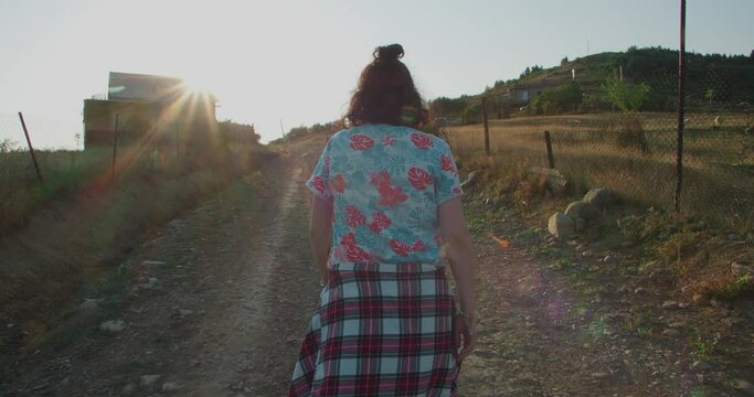 Girl walking on a village path
