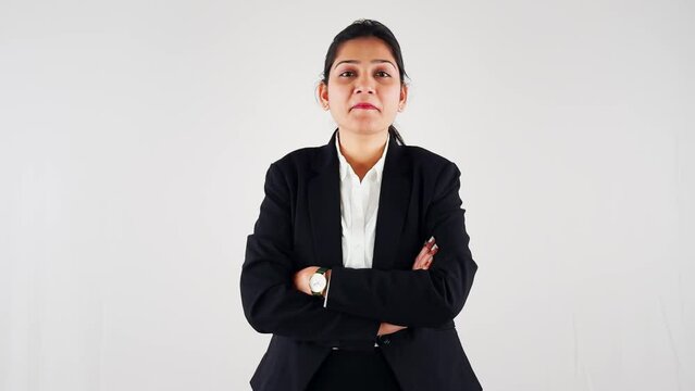 smiling business women formally dressed standing with arms crossed nodding neck up down gesture yes against a white background