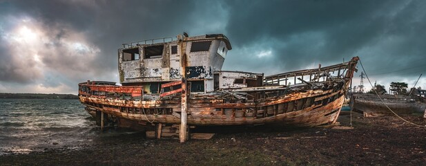 old fishing boat on the beach - Powered by Adobe