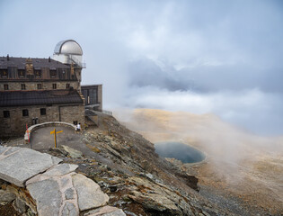 Gornergrat observatory in autumn and a misty alpine mountain landscape