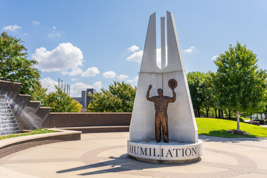 Tulsa, OK - Sept 16, 2021: In Hope Plaza, at Reconciliation Park, there are 3 sculptures depicting actual pictures from the 1921 race riot. "Humiliation" shows a man with his hands raised in surrender