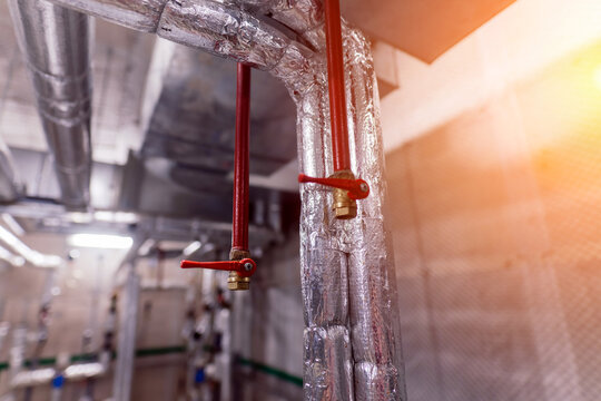 Interior industrial gas boiler with a lot of piping, pumps and valves