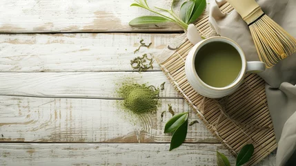 Fotobehang Flat lay photo with space for text. Matcha green tea on wooden background. Cup of matcha tea, bamboo matcha whisk. © Olga Troitskaja