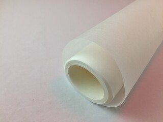 White baking parchment, on a white insulated background, with shades of rayon blue and pink....