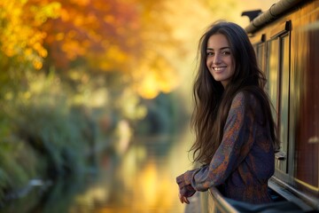 Young woman on a canal boat in the fall.