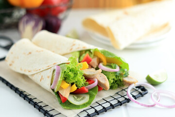 Two Fresh Chicken and Salad Tortilla Wraps on Wire Rack