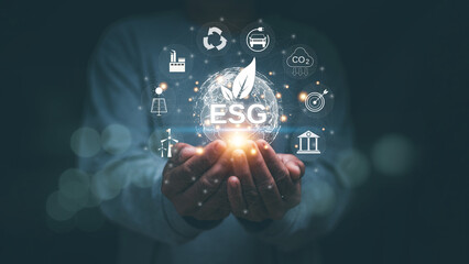ESG environment social governance investment business concept. Human hand holding virtual global with ESG word and environment icon. Sustainable environment, Environmental protection and conservation.