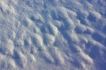 texture of snow in the sun, uneven with bumps and shadows from them. rough loose snow in the sun plane. 
