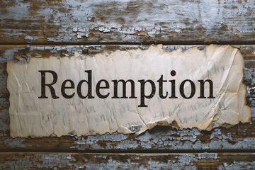 redemptionn text on grunge wooden background. vintage filtered image