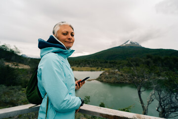 Naklejka premium tourist in Bahia Lapataia amidst mountains at Tierra del Fuego