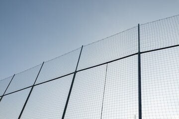 Wire fence around sport stadium to prevent ball to fly away