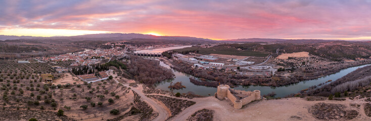 Aerial colorful sky sunset panoramic view of Flix new castle above the Ebro river in Spain with...