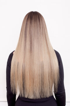 
Female back with long straight natural blonde hair in hairdressing salon
