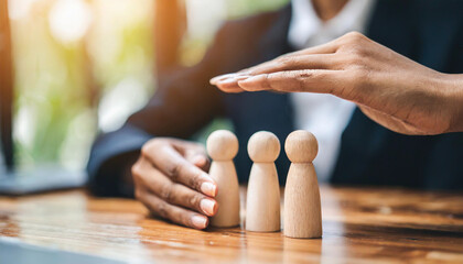 Woman's hands shield wooden figures, embodying protection and security with a determined gesture, symbolizing strength and guardianship