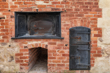 Black, woodfired ovens in the red brick wall at the old bakery at Inneston historic gypsum mining town - Innes National Park, Yorke Peninsula, South Australia