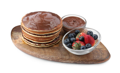 Tasty pancakes with chocolate paste and berries isolated on white