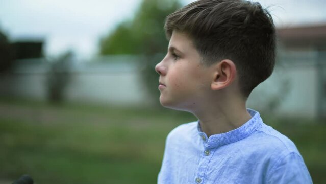 healthy foods, cute male child eats an appetizing ripe apple while walking in countryside