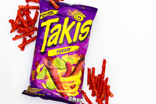 February 3, 2023. Spartanburg, SC USA. Rolling tortilla chips with chili peppers and lime by Takis Fuego