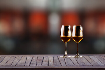 Wooden table with wine glasses and blurred bokeh on a dark background. Cafe-bar, restaurant-restaurant..