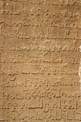 Inscriptions of Tamil language carved on the stone walls at Kailasanathar temple in Kanchipuram. Indian rock art relief carvings of Historical ancient vintage Tamil text in Temples. 