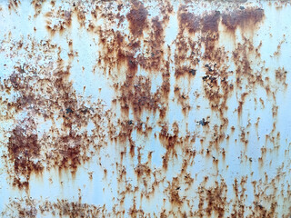 Rusty metal background with streaks of rust. Corroded metal background. Rust stains. Rusty corrosion.