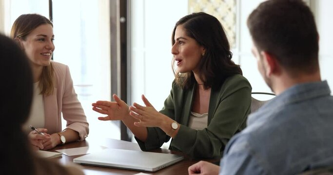 Woman company executives share solutions met in office board room with teammates. Negotiations, briefing event of staff. Workflow, group of successful young ambitious employees discussing joint task