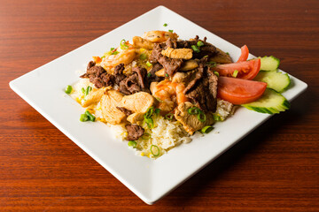 Sauteed shrimp, chicken and pork over rice