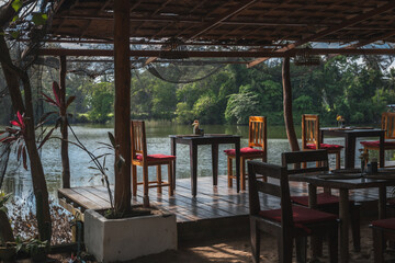 Tables and chairs by a riverside