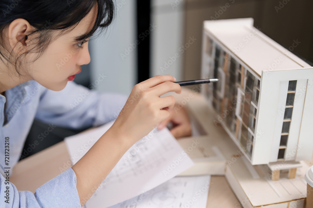 Poster asian architect engineer women working to examining design of architecture building model and taking