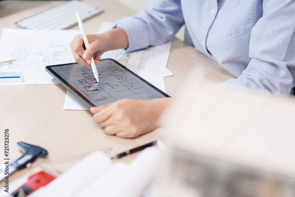 Poster asian architect engineer women using digital tablet to working and drawing architecture plan while c