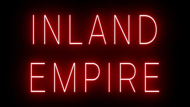 Flickering red retro style neon sign glowing against a black background for INLAND EMPIRE