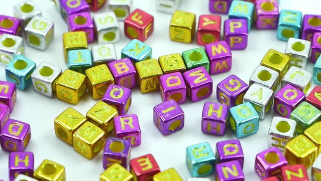 Multicolored alphablocks with english letters slow movement on a white background.