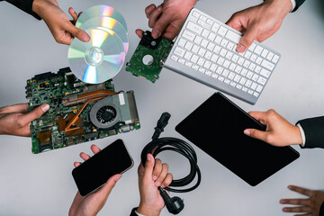 Top view hand holding electronic waste on isolated background. Eco-business recycle waste policy in...