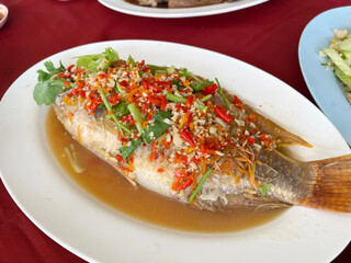 boiled fish with vegetables and herbs