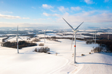Renewable energy wind turbines on the winter field. Green energy concept 