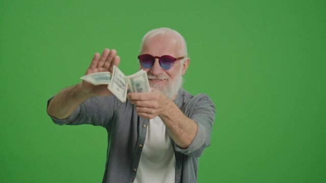 Green Screen. Portrait Of A Successful Old Man Throwing Money In Us Dollars. Investing in Pensions. Financial Planning for the Elderly.