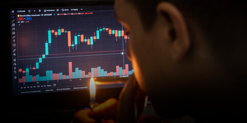 Man lighting cigarette while analyzing cryptocurrency stock charts