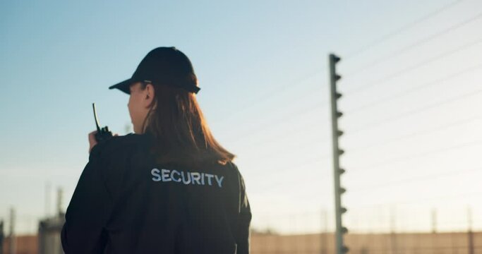 Security, radio and woman by fence for patrol inspection, investigation and property search. Surveillance, law and back of person with walkie talkie for safety, communication and protection service