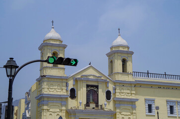 Colonial Latin American architecture downtown house building facades with busy traffic street, police and people tourists in old town Lima, Peru with every day big city life scenery