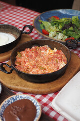 Turkish Menemen omelet in a frying pan. .