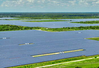 Aerial view of big sustainable electric power plant with many rows of solar photovoltaic panels for producing clean electrical energy. Renewable electricity with zero emission concept