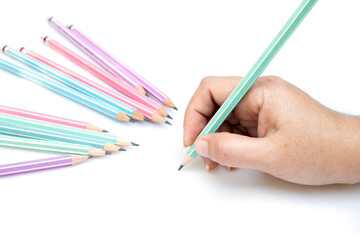Woman's hand holding a pencil to write isolated on a white background