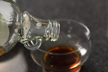 Pouring maple syrup into glass bowl