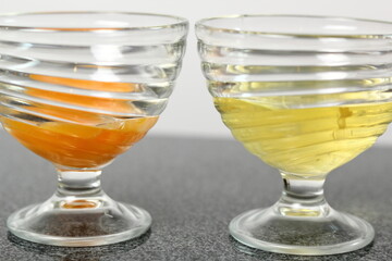 Two glass bowls. One with egg yolks, other with egg whites.